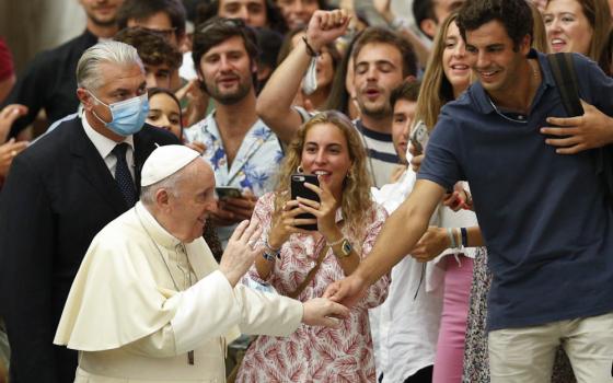 Pope Francis greets young people during his general audience in the Paul VI hall at the Vatican Sept. 1. (CNS/Paul Haring)