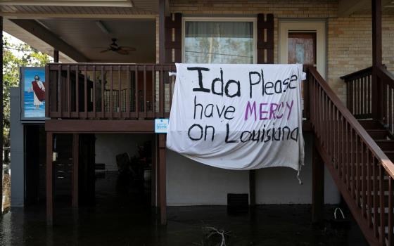 A blanket hangs outside a house Jean Lafitte, La., Sept. 2, 2021, following Hurricane Ida's landfall. The blanket reads "Ida please have mercy on Louisiana." (CNS photo/Marco Bello, Reuters)