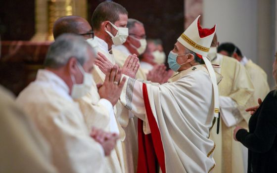 Cardinal Daniel DiNardo of Galveston-Houston greets newly ordained Deacon Bruce Flagg during an ordination Mass for permanent deacons at the Co-Cathedral of the Sacred Heart in Houston Feb. 20. (CNS/Texas Catholic Herald/James Ramos)