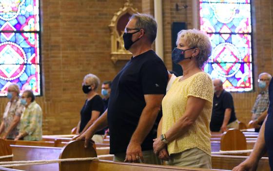 Parishioners at St. Vincent de Paul Church in Wheeling, W.Va., wear masks during Mass Aug. 28, 2021. (CNS photo/Colleen Rowan, The Catholic Spirit)