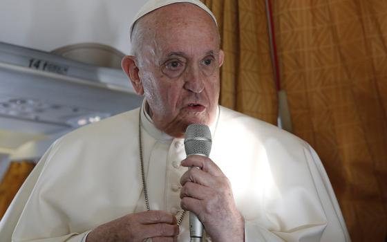 Pope Francis answers questions from journalists aboard his flight Sept. 15 from Bratislava, Slovakia, to Rome. (CNS/Paul Haring)