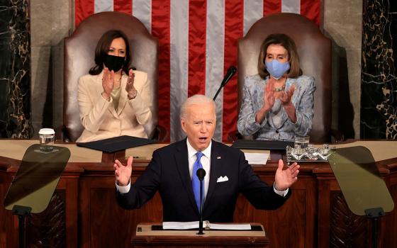 President Joe Biden addresses a joint session of Congress April 28 in Washington, as Vice President Kamala Harris and Speaker of the House U.S. Rep. Nancy Pelosi, D-Calif., applaud. (CNS/Chip Somodevilla, Pool via Reuters)