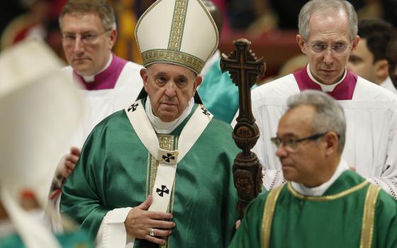 Pope Francis carries his pastoral staff as he leaves the concluding Mass of the Synod of Bishops for the Amazon at the Vatican Oct. 27, 2019. The pope plans to celebrate a Mass Oct. 10, 2021, to formally open the synodal process for the Synod of Bishops i