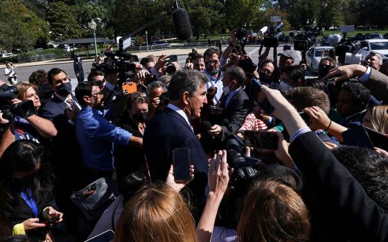 Sen. Joe Manchin, D-West Virginia, makes his way through a crowd of Capitol Hill reporters outside the U.S. Capitol in Washington Sept. 30, 2021. (CNS/Reuters/Leah Millis)