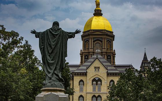 A statue of Jesus facing the Golden Dome with its statue of Mary atop the administration building of the University of Notre Dame is seen Aug. 6 in Notre Dame, Indiana. (CNS/Chaz Muth)