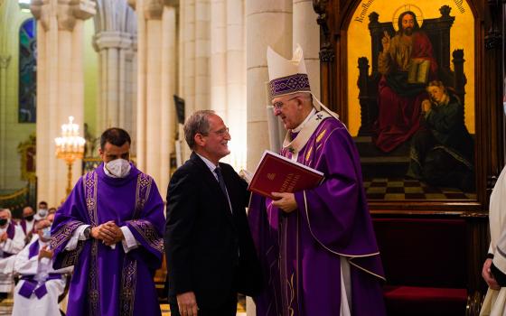 Carlos Metola, postulator of the sainthood cause of Carmen Hernández, presents to Cardinal Carlos Osoro Sierra of Madrid the written request that the sainthood process for her be formally opened, during a Mass in the cathedral in Madrid July 19, 2021. (CN