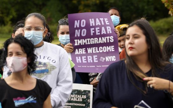 A woman holds a sign during a march and rally in support of immigration reform Oct. 16, 2021. (CNS photo/Gregory A. Shemitz)