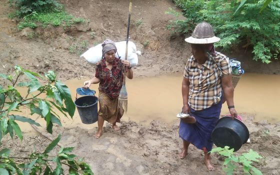 Villagers displaced by fighting in eastern Myanmar cross a river in Kayah state June 12, 2021. (CNS photo/Reuters)