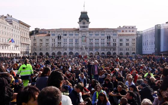 People protest against the implementation of the coronavirus disease "green pass" in the workplace in demonstration at the Unity of Italy Square (Piazza Unita d'Italia) Oct. 18, 2021. (CNS photo/Borut Zivulovic, Reuters)