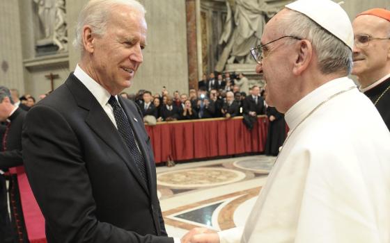 Pope Francis greets then-U.S. Vice President Joe Biden in St. Peter's Basilica at the Vatican March 19, 2013, as the new pontiff receives dignitaries following his inaugural Mass. (CNS/Vatican Media)