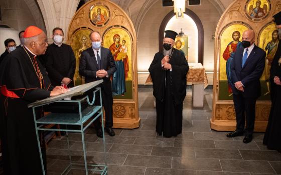 Washington Cardinal Wilton D. Gregory, left, greets Ecumenical Patriarch Bartholomew of Constantinople, center, during the Orthodox spiritual leader's Oct. 25, 2021, visit to Georgetown University's Copley Crypt Chapel. (CNS photo/Phil Humnicky, Georgetow