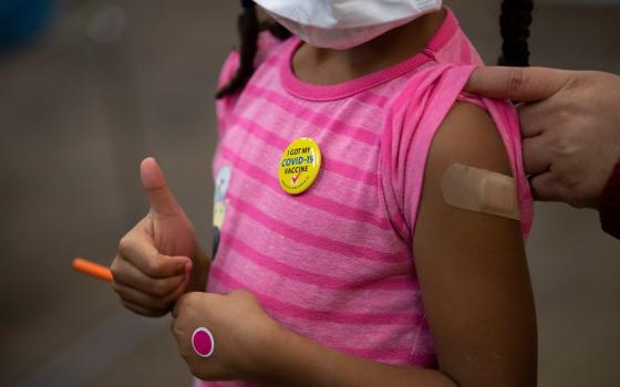 Josclyn Ledisma, 5, gives a thumbs up after receiving her first dose of the COVID-19 vaccine inside Mary's Center in Washington Nov. 3, 2021. (CNS photo/Tom Brenner, Reuters)