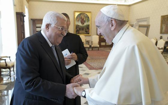 Pope Francis and Palestinian President Mahmoud Abbas exchange greetings during an audience Nov. 4 at the Vatican. (CNS/Vatican Media)