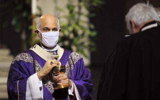 San Francisco Archbishop Salvatore Cordileone distributes Communion during a Mass for the homeless Nov. 6 at the Cathedral of St. Mary of the Assumption. (CNS photo/David Maung)