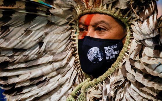 Indigenous Amazon delegate Romancil Gentil Kreta, wearing a protective mask with a logo of the U.N. Climate Change Conference, looks on during the conference in Glasgow, Scotland, Nov. 3, 2021. (CNS photo/Phil Noble, Reuters)