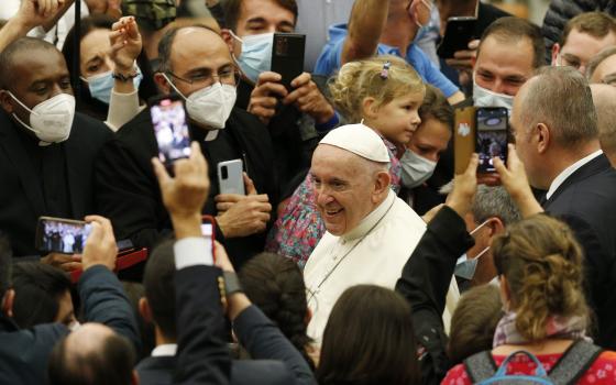 Pope Francis greets the crowd as he leaves his general audience in the Paul VI hall at the Vatican Nov. 10, 2021. (CNS photo/Paul Haring)