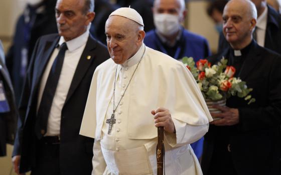 Pope Francis carries a pilgrim's staff as he arrives for a meeting with the poor at the Basilica of St. Mary of the Angels in Assisi, Italy, Nov. 12, 2021. (CNS photo/Paul Haring)