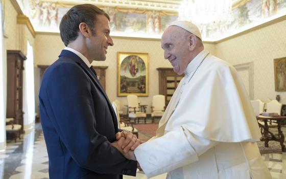 Pope Francis shakes hands with French President Emmanuel Macron during an audience at the Vatican Nov. 26, 2021. (CNS photo/Vatican Media)