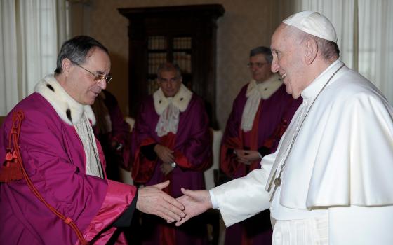 Vatican Judge Venerando Marano listens as the president of the Vatican City State tribunal, Giuseppe Pignatone, speaks during the third session of the trial of six defendants accused of financial crimes, including Cardinal Angelo Becciu, at the Vatican Ci