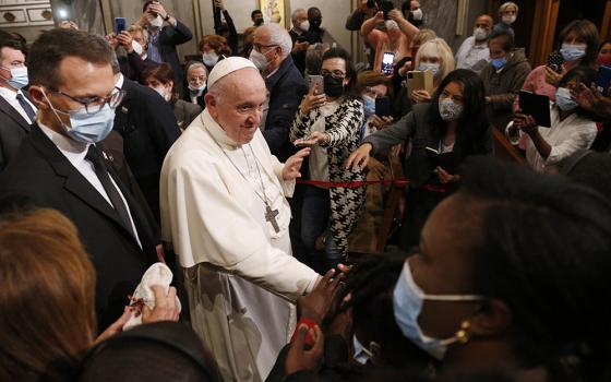 Pope Francis greets people as he leaves an ecumenical prayer with migrants in the Church of the Holy Cross Dec. 3 in Nicosia, Cyprus, Dec. 3. (CNS/Paul Haring)