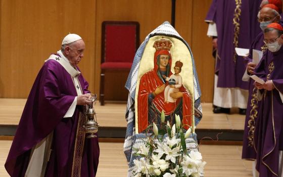 Pope Francis uses incense to venerate a Marian image as he celebrates Mass in the Megaron Concert Hall in Athens, Greece, Dec. 5, 2021