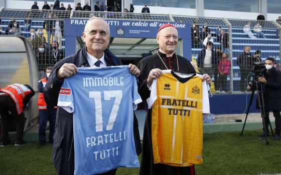 Claudio Lotito, president of the Lazio professional soccer club, and Cardinal Gianfranco Ravasi, president of the Pontifical Council for Culture, hold shirts for their respective teams before a friendly match between the Vatican's "Fratelli Tutti" squad a