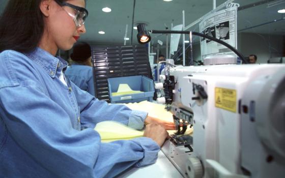 A worker sews air bags for Ford at Aguirre Safety Technologies in Detroit Aug. 12, 2004. (CNS photo/Jim West)