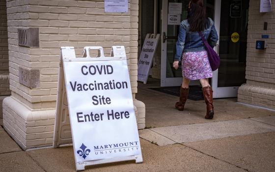 Students and faculty members at Marymount University arrive at one of the athletic buildings on the Catholic college's Arlington, Va., campus, to receive the Pfizer COVID-19 vaccine during a coronavirus vaccine clinic April 21, 2021. (CNS photo/Chaz Muth)