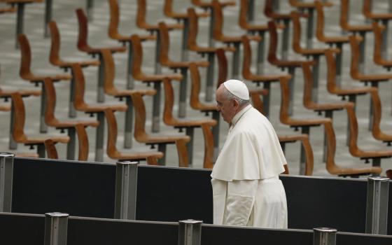 Pope Francis leaves Paul VI hall at the Vatican after a meeting Dec. 19, 2021, with children assisted by the Vatican's St. Martha pediatric clinic. (CNS photo/Paul Haring)