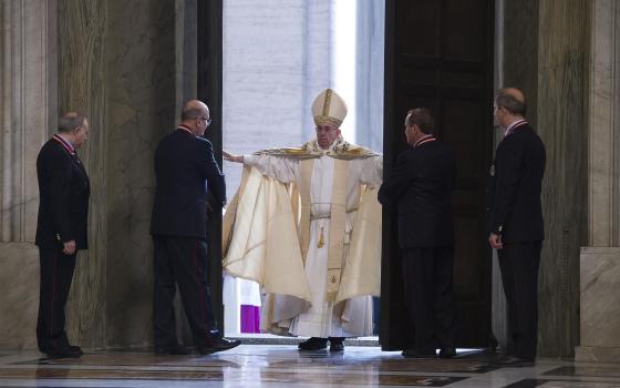 In this 2015 file photo, Pope Francis opens the Holy Door of St. Peter's Basilica to inaugurate the Jubilee Year of Mercy at the Vatican. (CNS photo/L'Osservatore Romano, handout)