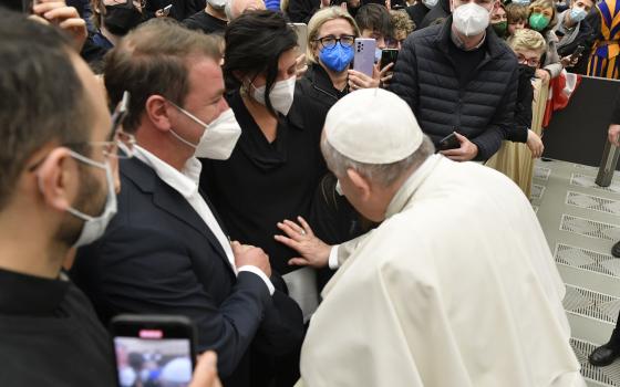 Pope Francis blesses a woman's unborn child at the end of his weekly general audience Dec. 29, 2021, in the Vatican's Paul VI hall. (CNS photo/Vatican Media)