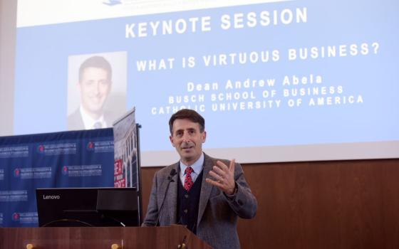 Man speaking in front of screen 