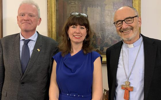 Chris Trott, British ambassador to the Holy See; Anna Rowlands, a professor and author; and Canadian Cardinal Michael Czerny, interim president of the Dicastery for Promoting Integral Human Development, pose March 7, at Trott’s residence in Rome after a discussion of Rowland's book, Towards a Politics of Communion. (CNS/Cindy Wooden)