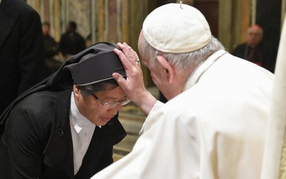 Pope Francis blesses a nun during an audience at the Vatican with students and staff of the Claretian Institute of the Theology of Consecrated Life in Rome, Nov. 7, 2022. 