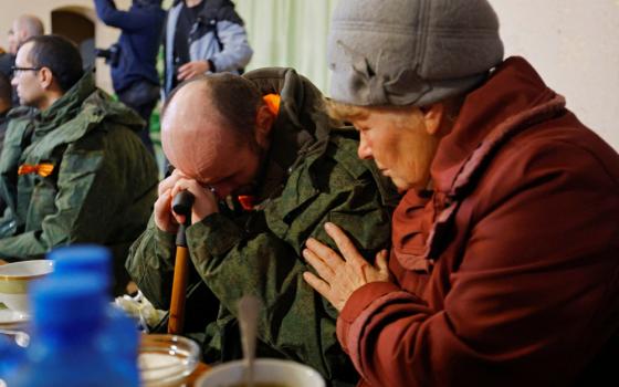 A serviceman from the Russian-controlled Donetsk region of Ukraine sits with his mother in Amvrosiivka, Ukraine, Nov. 6, 2022, following his release in a recent prisoner exchange.