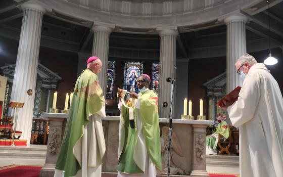 Dublin Archbishop Dermot Farrell receives his pallium from Archbishop Jude Thaddeus Okolo, papal nuncio, center, at St. Mary's Pro Cathedral in Dublin Aug. 7, 2021. (CNS photo/courtesy John McElroy)