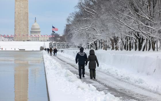 People in Washington walk along the National Mall following a snowstorm Jan. 3, 2022. (CNS/Reuters/Evelyn Hockstein)