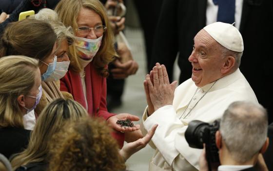 Pope Francis gestures as he greets people during his general audience in the Paul VI hall at the Vatican Jan. 5, 2022. (CNS photo/Paul Haring)