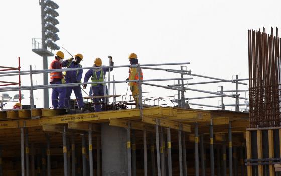 Migrant laborers work at a construction site in Doha, Qatar, March 26, 2016. (CNS photo/Naseem Zeitoon, Reuters)