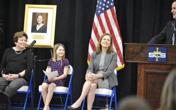 Father Tim Hedrick, pastor of St. Catherine of Siena Parish in Metairie, La., welcomes U.S. Supreme Court Associate Justice Amy Coney Barrett after her speech to the Catholic school Jan. 24, 2022. (CNS photo/Peter Finney Jr., Clarion Herald New Orleans)