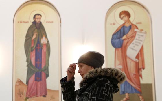 A believer attends a liturgy at the Ukrainian Greek Catholic Cathedral of the Resurrection of Christ in Kyiv, Ukraine, Jan. 26. (CNS/Reuters/Valentyn Ogirenko)