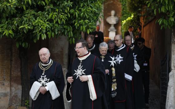 Members of the Knights of Malta walk in a procession at the start of voting to elect a new leader in Rome in this May 2, 2018. (CNS photo/Paul Haring)