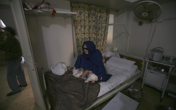 A patient sits on her bed at Marie Adelaide Leprosy Center in Karachi, Pakistan, in this Jan. 25, 2008. (CNS photo/Athar Hussain, Reuters)