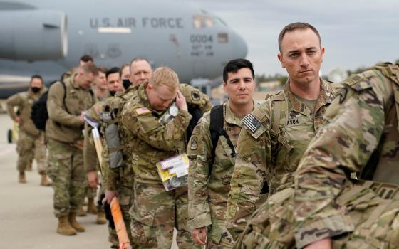 Military personnel from the 82nd Airborne Division and 18th Airborne Corps in Fort Bragg, N.C., board a C-17 transport plane for deployment to Eastern Europe Feb. 3, 2022, amid escalating tensions between Ukraine and Russia. (CNS photo/Bryan Woolston, Reu