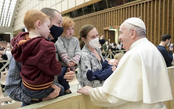 Pope Francis greets family members during his general audience in the Paul VI hall at the Vatican Feb. 9, 2022. (CNS photo/Vatican Media)