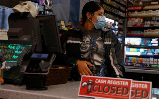 Ariana Mora of Jerome, Idaho, works while 8 months pregnant Oct. 27, 2021. (CNS photo/Shannon Stapleton, Reuters)