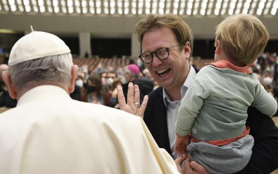 Pope Francis greets Christopher Lamb, Rome correspondent for The Tablet, during his general audience in the Paul VI hall at the Vatican Feb. 16, 2022. (CNS photo/Vatican Media)