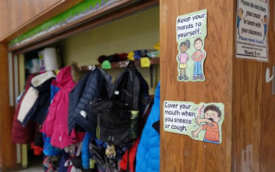 Signs at South Boston Catholic Academy in Boston remind children of precautions to prevent the spread of COVID-19 in the classroom Jan. 28, 2021. (CNS photo/Allison Dinner, Reuters)