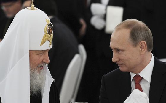 Russian President Vladimir Putin, right, listens to Russian Orthodox Patriarch Kirill of Moscow during a reception at the Kremlin in Moscow in this July 28, 2015, file photo. (CNS)