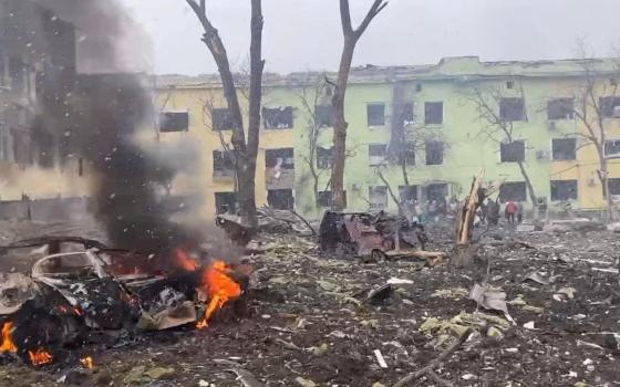 A view shows cars and a building of a hospital destroyed by an airstrike in Mariupol, Ukraine, in this handout picture released March 9, 2022. \(CNS photo/Press service of the National Police of Ukraine/handout via Reuters) 